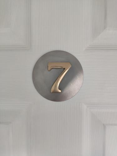 a metal number seven hanging on a wall at Q Accommodation in Blackpool