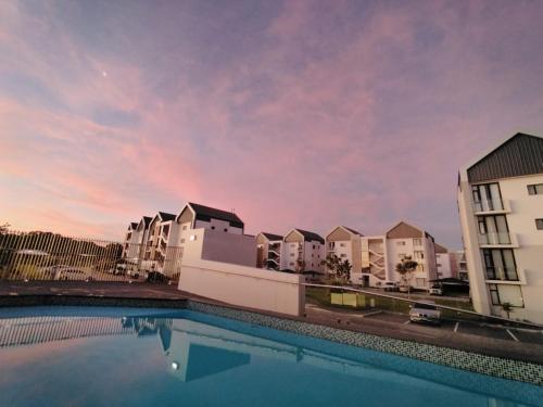 a swimming pool in front of some buildings at Coastal Elegant At Bellamare in Summerstrand