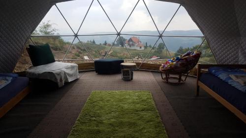 a room with a large window with a view of a mountain at Dome Home Tents Taor in Valjevo