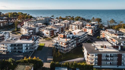 an aerial view of an apartment complex next to the ocean at Klifowa Rewal, Sun & Snow in Rewal