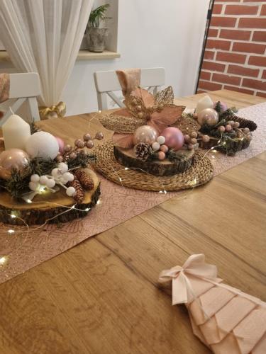 a table with two baskets of christmas decorations on it at HOOPOVO HOUSE Fruška gora in Irig