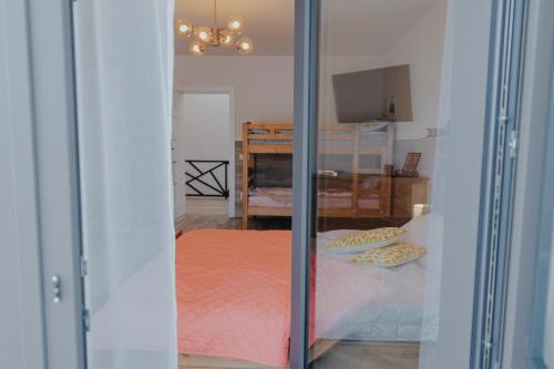 a view of a bedroom through a sliding glass door at IoanaGuestHouse in Turda