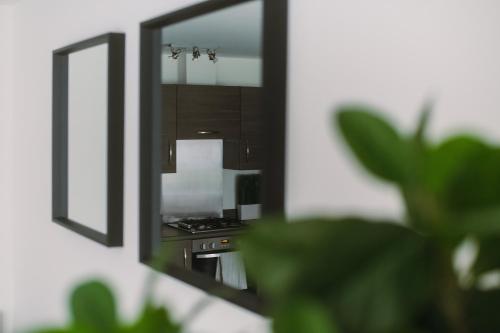 a reflection of a stove in a mirror at SmartSleep Apartments in Glasgow