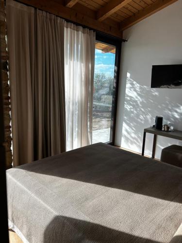 a bedroom with a bed and a large window at Nuovo B&B Colline San Benedetto in Marostica