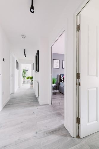 an open hallway with white walls and a mirror at SmartSleep Apartments in Glasgow