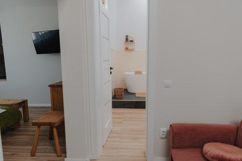 a living room with a door leading into a bathroom at IoanaGuestHouse in Turda