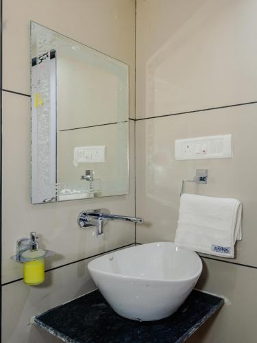 a bathroom with a white sink and a mirror at Hotel Zillion Executive Near US Consulate Bandra Kurla Complex Mumbai Near Mumbai Airport Mumbai in Mumbai