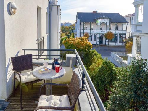 a balcony with a table and chairs and a building at Villa Annika - Apt. 08 in Ostseebad Sellin