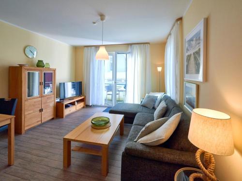 a living room with a couch and a table at Villa Annika - Apt. 08 in Ostseebad Sellin