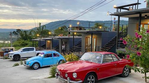 two old cars parked in front of a house at Phurubmok khaokho in Khao Kho