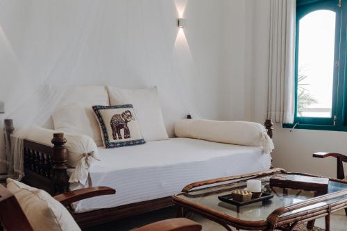 a living room with a bed and a table at Lighthouse Ahangama in Ahangama