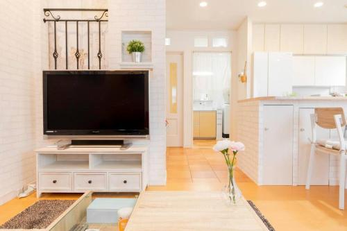 a living room with a large flat screen tv at Kishisato Japanese House QB-1 in Osaka