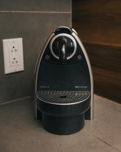 a iron is sitting on a counter next to a lightswitch at Lake Resort Suite: Views & Amenities in Lac-Superieur