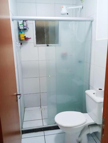uma casa de banho com um WC e uma cabina de duche em vidro. em Apê da Mel - Recife PE no Recife