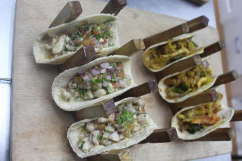 a group of four tacos on a cutting board at Seconds Hostel - Colombo in Colombo