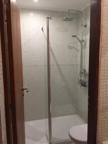a glass shower with a toilet in a bathroom at Alma N' Sleep in Almancil