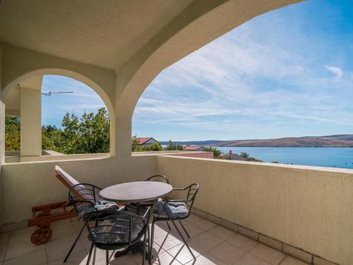 a balcony with a table and chairs and a view of the water at Apartment Vlasta-1 by Interhome in Jadranovo