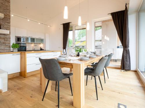 a kitchen and dining room with a wooden table and chairs at Apartment Christine Penthouse by Interhome in Eben im Pongau