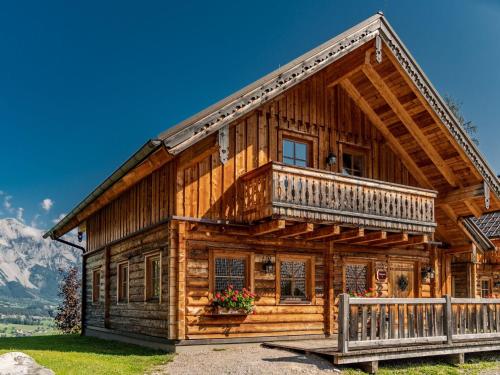 a log cabin with a balcony and mountains at Holiday Home Försterin by Interhome in Pichl