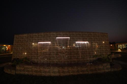 a brick wall with lights on it at night at SKD RESORT AND CLUB in Barvāla