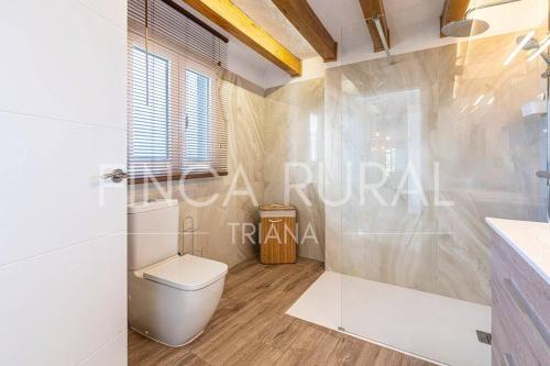 a white bathroom with a toilet and a shower at Finca Rural Triana in Santa Cruz de Tenerife