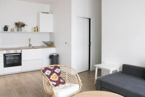 a living room with a chair and a kitchen at Spacious appt close to Place Monge in Paris