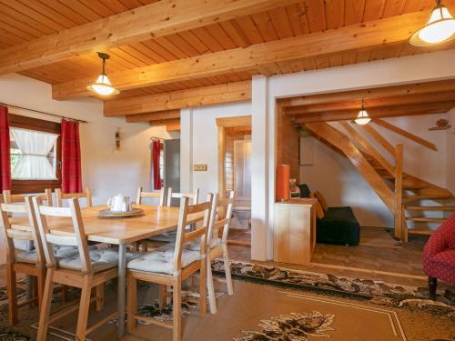a dining room with a wooden table and chairs at Holiday Home Pod Liščím Kopcem by Interhome in Horní Branná