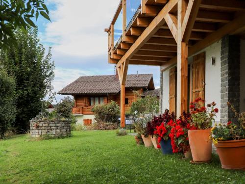 a house with potted plants on the lawn at Chalet Chalet Picoulet by Interhome in Villars-sur-Ollon