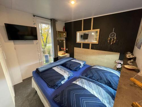 a bed with a blue comforter in a bedroom at Holiday Home Ulrike by Interhome in Wemding