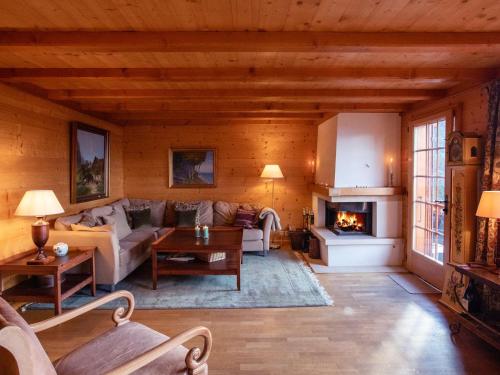 a living room with a couch and a fireplace at Apartment La-Ina by Interhome in Chesières