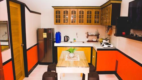 a small kitchen with a table and a refrigerator at RB Modern Condos in Zamboanga