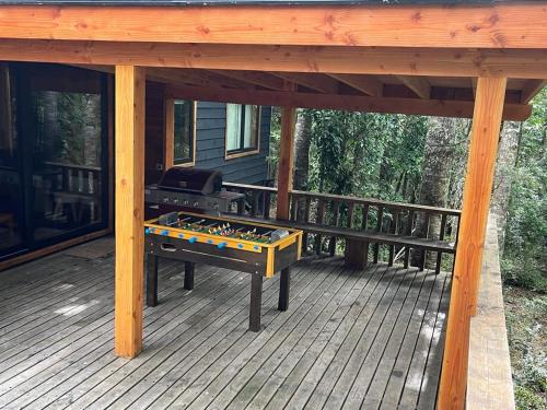 a grill on a screened porch of a house at Espectacular y Amplia Casa en Reserva Huilo Huilo in Huilo Huilo