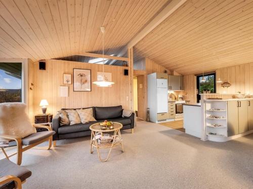 a living room with a couch and a table at Holiday Home Diuri - 300m to the inlet in The Liim Fiord by Interhome in Struer
