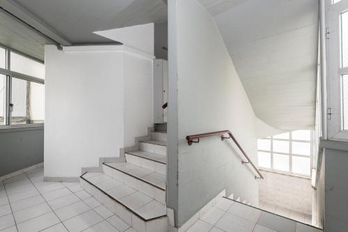 escalera en una habitación con paredes blancas y ventana en Olivais Vintage by Homing, en Lisboa
