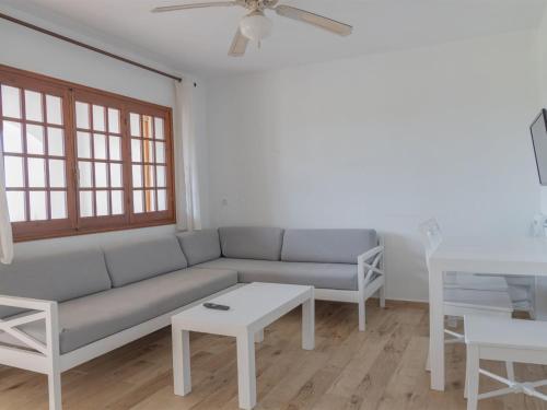 a living room with a couch and a table at Apartment Son Bou Gardens PLUS by Interhome in Son Bou