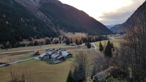 an aerial view of a house in a field in the mountains at Chalet Alpin Luxe, Jacuzzi, Vue in Champagny-en-Vanoise