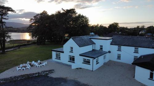 an aerial view of a white house with chairs at Rock House Sligo in Riverstown