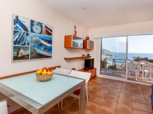 a dining room with a table and a view of the ocean at Apartment Codolar by Interhome in Tossa de Mar