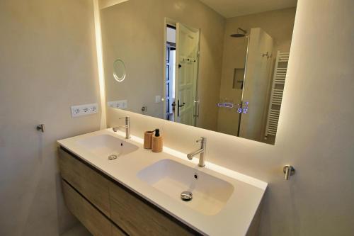 a bathroom with a sink and a large mirror at Villa La Vista in Calonge