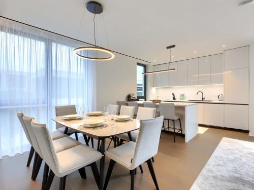 a dining room and kitchen with a table and chairs at Holiday Home Semi-detached Villa Crveni vrh 1-2-3- by Interhome in Savudrija