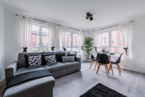 a living room with a couch and a table at RelaxingSleep Apartments in Glasgow