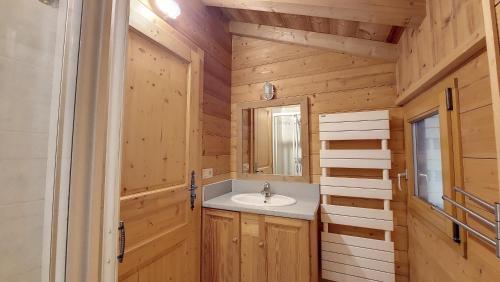 a bathroom with a sink and a mirror at Chalet MB in Saint-Jean-d'Aulps