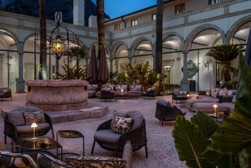 a courtyard with chairs and a fountain in a building at San Domenico Palace, Taormina, A Four Seasons Hotel in Taormina