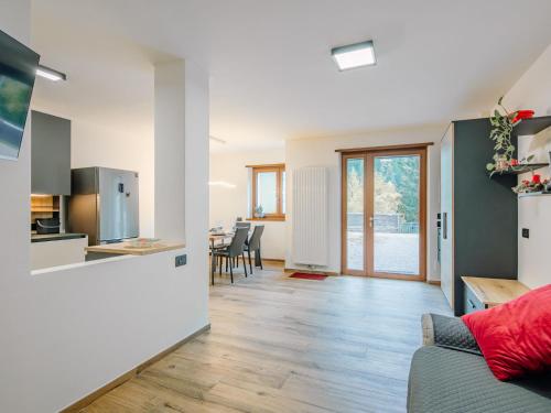 a kitchen and living room with a couch and a table at Apartment Enrosadira-9 by Interhome in Alba di Canazei