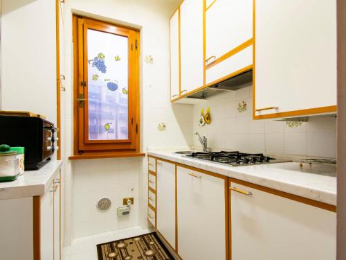 a kitchen with a stove and a window at Apartment Le Motte by Interhome in Abetone