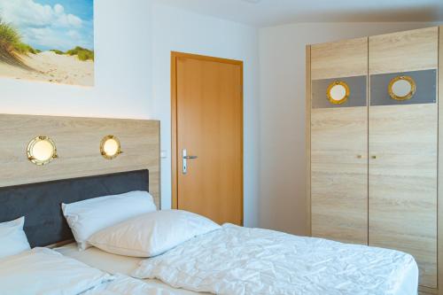 En eller flere senge i et værelse på Hanse Appartement II Warnemünde