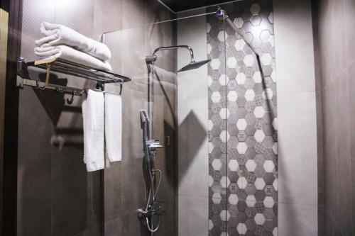 a bathroom with a shower with a shower curtain at 7 Rooms Hotel in Tserovani