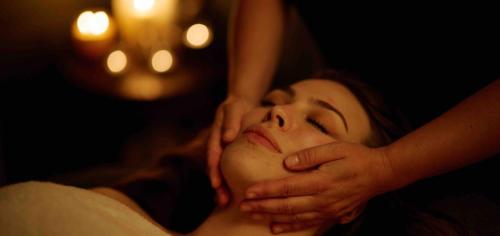 a woman is getting her face examined by a therapist at Murrayshall Country Estate in Perth