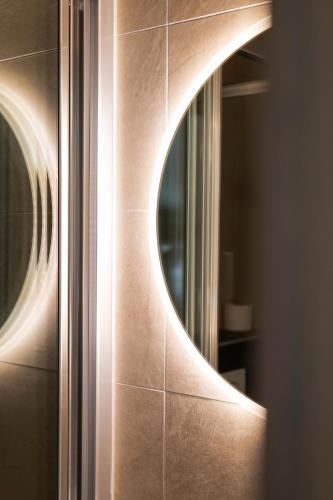 a bathroom with a mirror on a wall at Le Motel du Gaschney in Muhlbach-sur-Munster