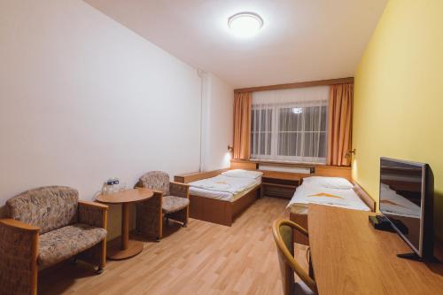 a hospital room with a bed and a table at Hotel Annahof in Domašov